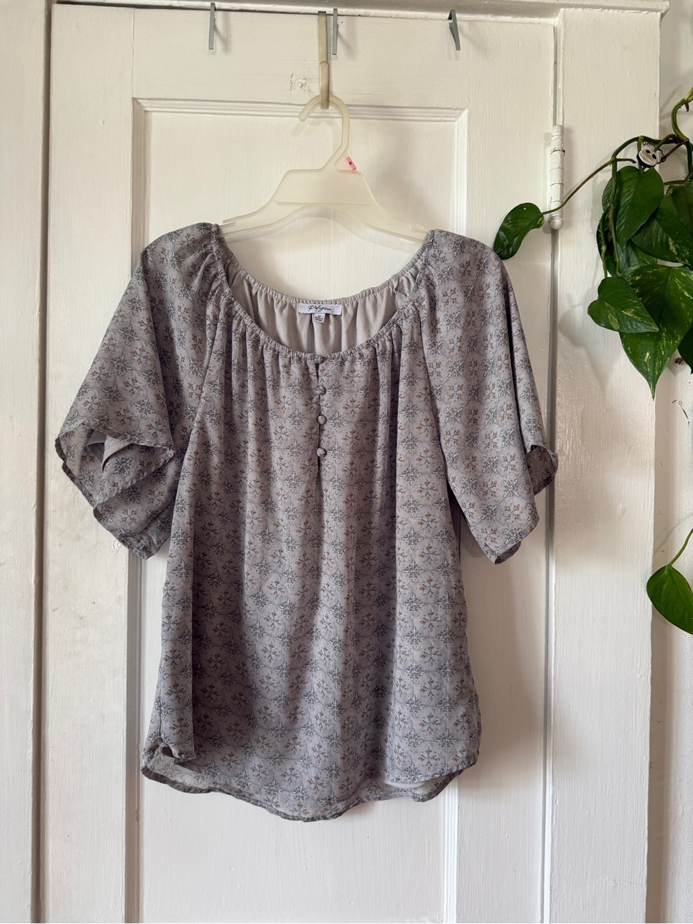 grey printed blouse by the brand Polagram